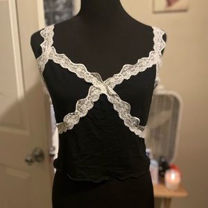 Black top with lacy details and lace straps.
